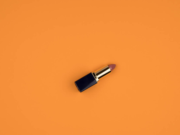 Open lipstick on an orange background. Cosmetics. Close-up. - Fotó, kép