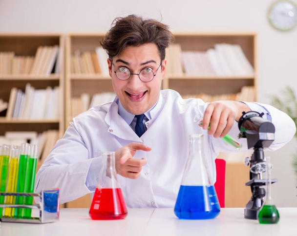 Mad crazy scientist doctor doing experiments in a laboratory - Photo, Image