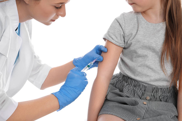 Little girl receiving chickenpox vaccination on white background. Varicella virus prevention - Zdjęcie, obraz