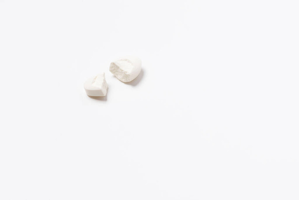 The tablet is white broken into two halves on white background. Isolated - Photo, image