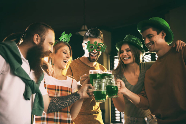 Group of friends toasting with green beer in pub.St. Patrick's Day celebration - Photo, image