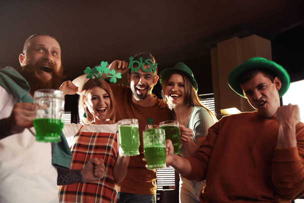 Group of friends with glasses of green beer in pub. St. Patrick's Day celebration - Fotografie, Obrázek