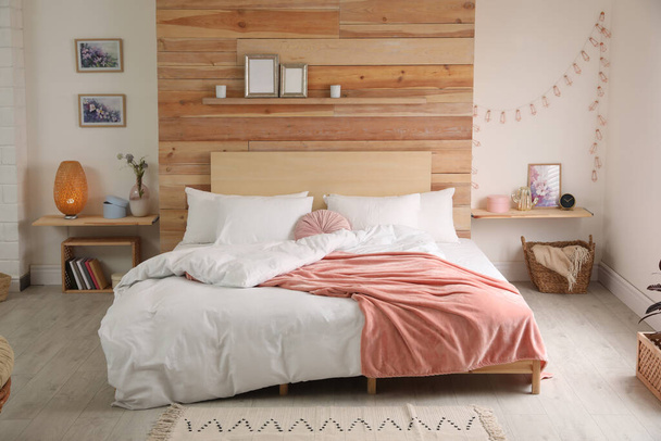 Stylish room interior with big comfortable bed - Photo, image