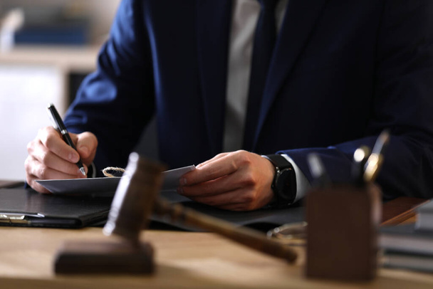 Male lawyer working at table in office, closeup - Foto, Imagen