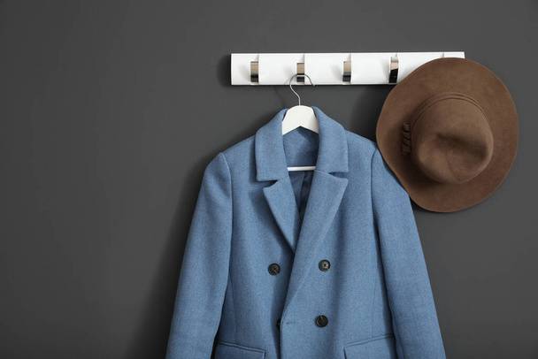Coat and hat on wall hanger in stylish hallway interior - Фото, изображение