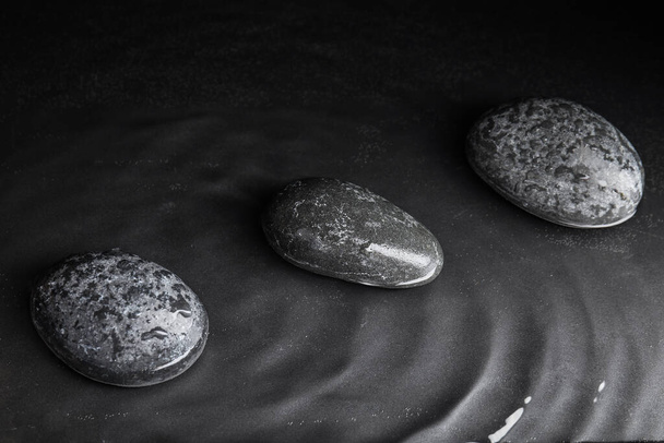 Stones in water on grey background. Zen lifestyle - Zdjęcie, obraz