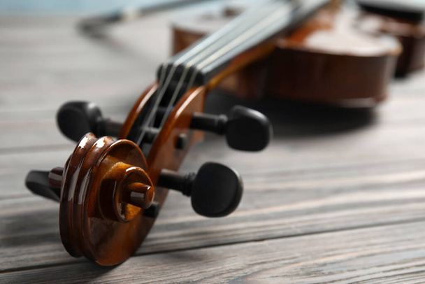 Classic violin on wooden background, closeup view - Фото, зображення