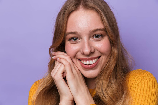 Photo of happy young woman smiling and looking at camera isolated over blue background - Photo, image