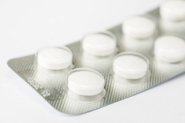 Closeup λευκά αντιβιοτικά κάψουλα χάπια σε συσκευασία κυψέλης. Ιστορικό φαρμακείου. Αντιμικροβιακή αντοχή. Φαρμακευτική βιομηχανία. Παγκόσμια υγειονομική περίθαλψη. - Φωτογραφία, εικόνα