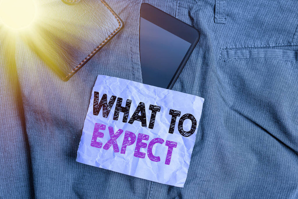Word writing text What To Expect. Business concept for asking about regard something as likely to happen occur Smartphone device inside trousers front pocket with wallet and note paper. - Zdjęcie, obraz