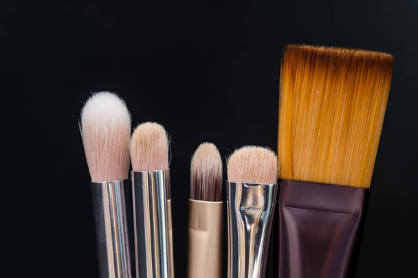 Set of makeup brushes on black background - Foto, Bild