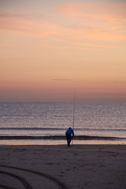 Fisherman on the shore of the beach. Colors of nature - Foto, imagen