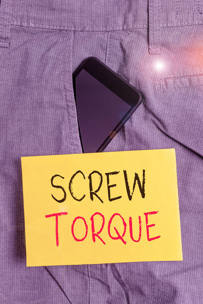 Word writing text Screw Torque. Business concept for measure of the twisting force required to spin the nut Smartphone device inside formal work trousers front pocket near note paper. - Photo, Image