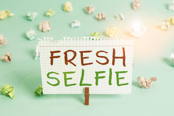 Word writing text Fresh Selfie. Business concept for take a picture of yourself with no makeup filter or edit Colored crumpled rectangle shaped reminder paper light blue background. - Photo, Image