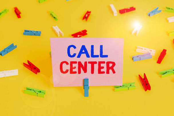 Handwriting text writing Call Center. Concept meaning an office in which large numbers of telephone calls are handled Colored clothespin papers empty reminder yellow floor background office. - Fotoğraf, Görsel