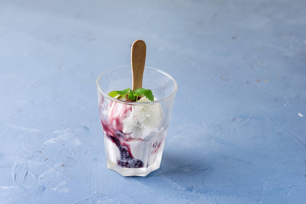 Delicious Homemade Vanilla Ice Cream with Jam and Mint in Glasses Blue Background Horizontal - Valokuva, kuva