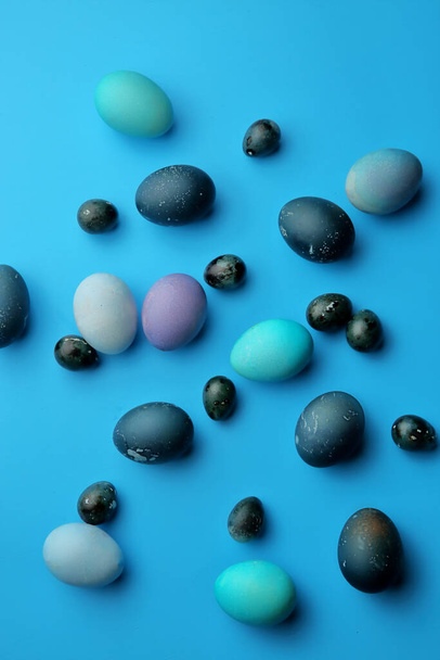 Easter chicken and quail eggs on a pastel blue background. The view from the top. Easter concept. - Photo, image
