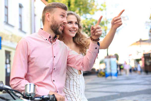 Young beautiful couple riding on motorbike. Adventure and vacations concept - Fotografie, Obrázek