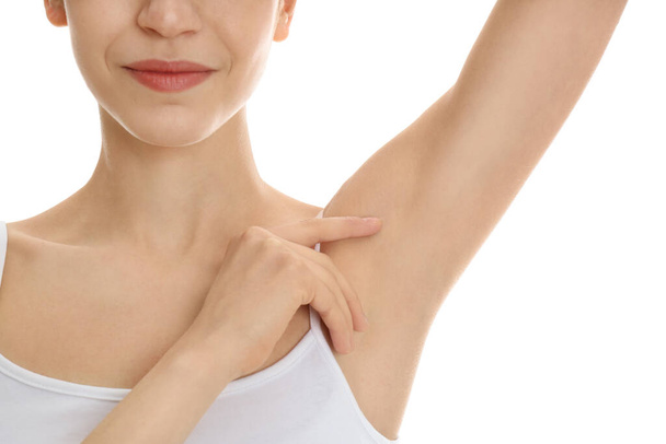 Young woman showing armpit with smooth clean skin on white background, closeup - Zdjęcie, obraz