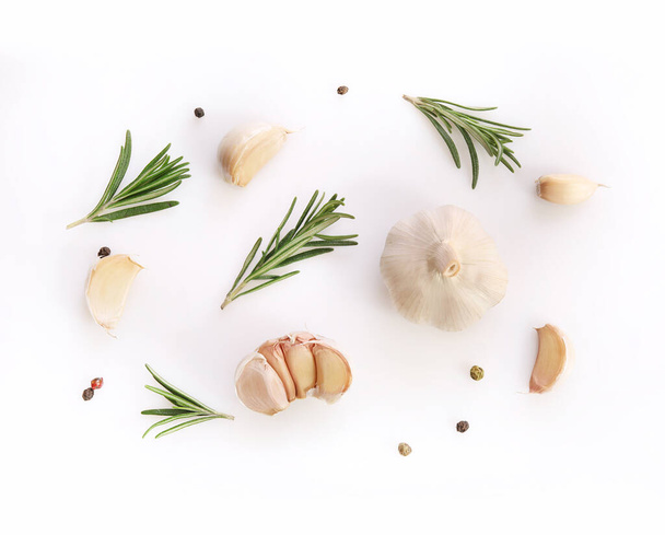 Garlic and rosemary on white background. Flat lay - Foto, afbeelding