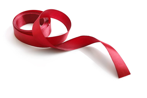 Shiny red satin ribbon isolated on white background - 写真・画像