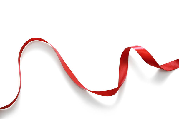 Shiny red satin ribbon isolated on white background - 写真・画像
