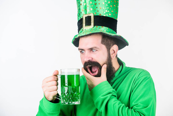 Man brutal bearded hipster drink pint beer. Green beer mug. Drinking beer part of celebration. Irish pub. Alcohol consumption integral part saint patricks day. Discover culture. Irish tradition - Fotó, kép