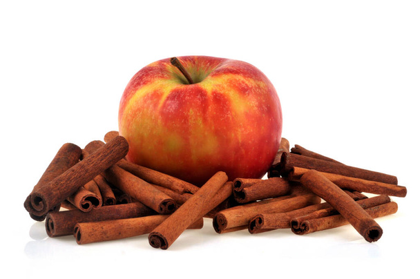 Apple with cinnamon sticks close up on white background - Φωτογραφία, εικόνα