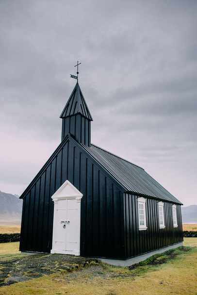 Icelandic landscape with a black church. - Zdjęcie, obraz