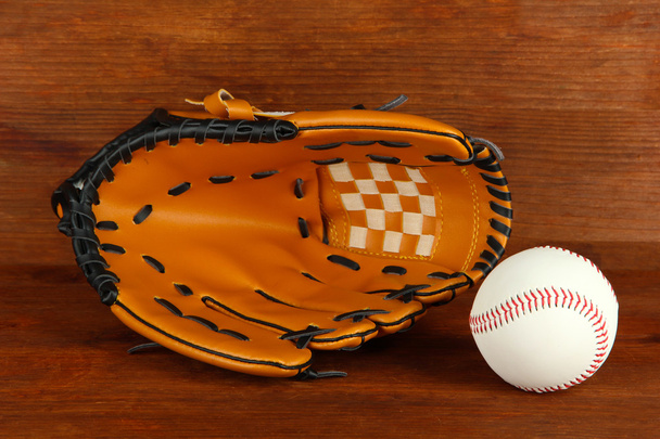 Baseball glove and ball on wooden background - Фото, зображення