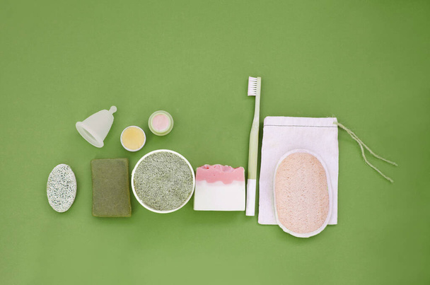 Set of everyday care of ecological products. Zero waste concept. Flat lay on green - Photo, Image