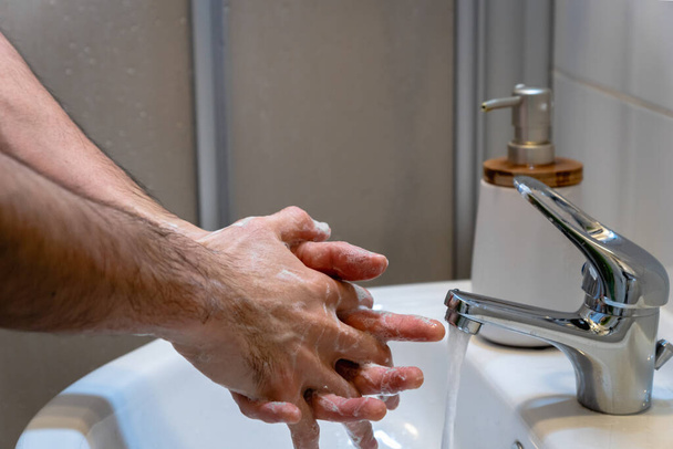 Washing hands with soap  - proper hand washing to stay healthy against infection, virus, flu - Photo, image