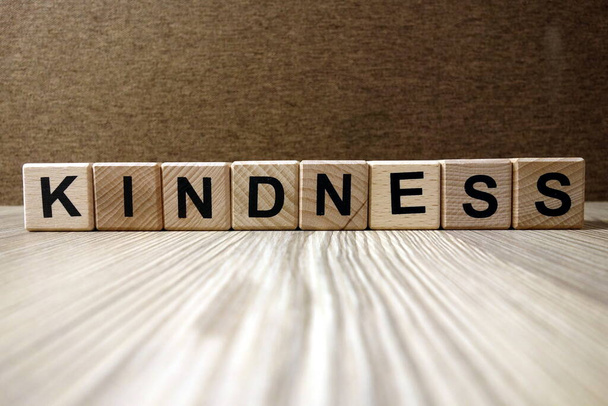 Word kindness from wooden blocks, friendliness and goodness concept - Photo, Image