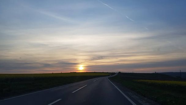 national road in the background with sunset - Photo, Image
