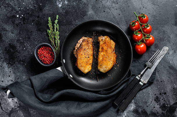 Grilled duck Breasts in a pan. Black background. Top view - Photo, Image