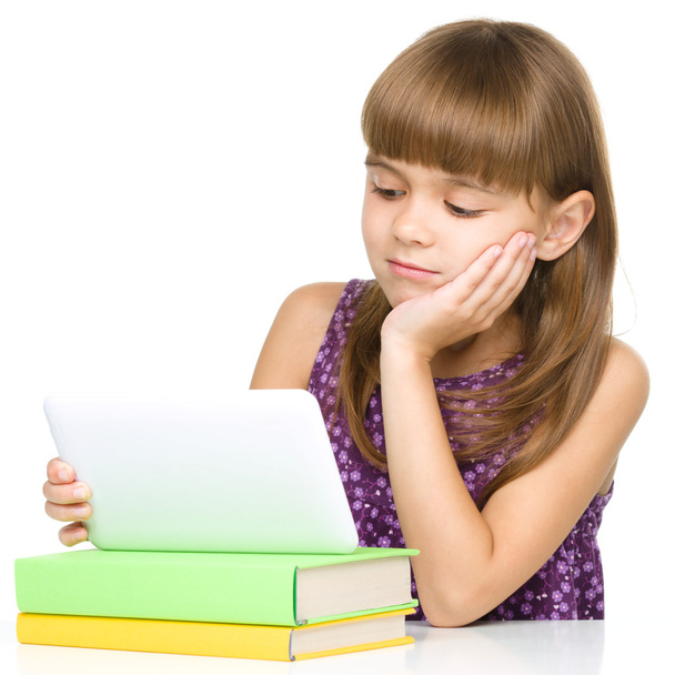 Young girl is using tablet - 写真・画像