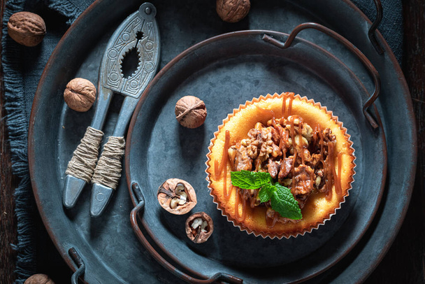 Sweet and yummy walnut cheesecake on dark plate - Φωτογραφία, εικόνα
