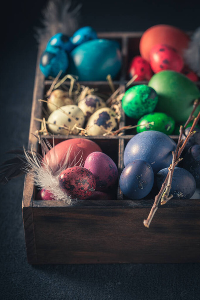 Quail and hen eggs for Easter in dark wooden box - Foto, imagen