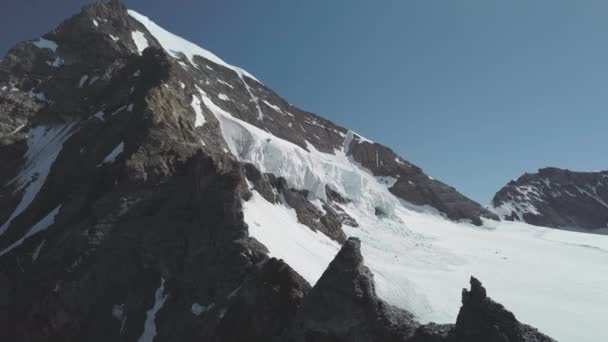 Mountain Peak in Switzerland Partially Covered in Snow and Smaller Mountains - Video