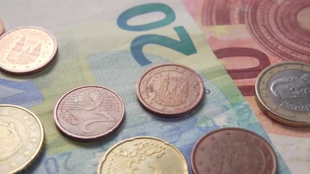 Euro coins and cents on banknotes sparkle in the sunlight. Dolly macro shot - Záběry, video