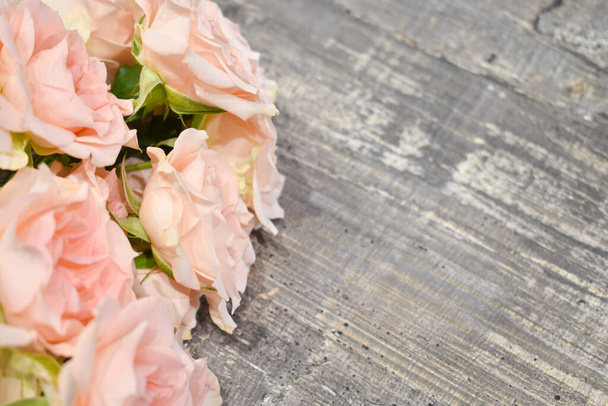 beautiful fresh flowers on a gray wooden background. - Photo, image