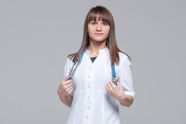 Portrait of a beautiful female doctor standing with stethoscope - Foto, Imagem