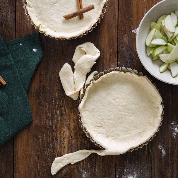 Ingredients for cooking apple tart on wooden table in a bakery top view - 写真・画像