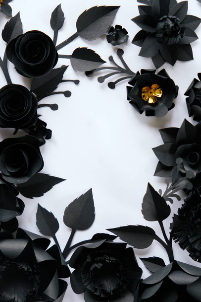Black paper flowers on white background. Cut from paper. Gothic frame - Фото, изображение
