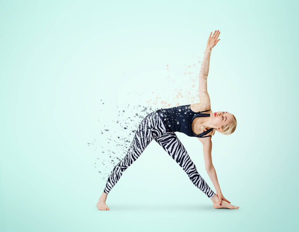 Woman in yoga posture decay on particles. Dispersion effect. - Photo, Image