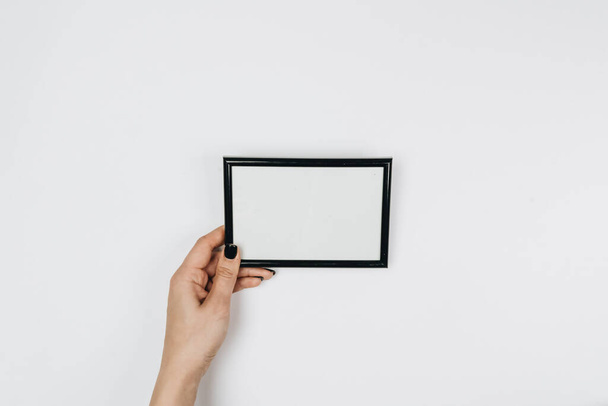 female hands holding a picture frames and copy space for your text - Photo, Image