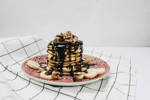  plate with cookies, chocolate topping, walnuts and sliced bananas - Photo, Image