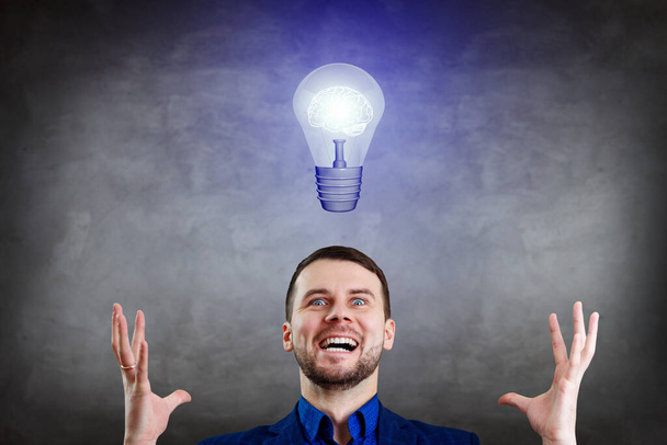 Businessman thinking and pointing finger on light bulb over head. - Photo, Image