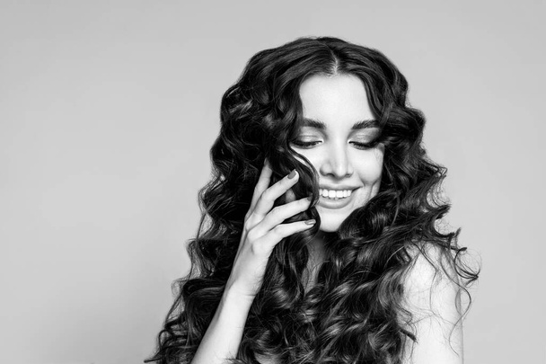 Black and white fashion portrait of a beautiful young brunette with wavy hair. - Φωτογραφία, εικόνα