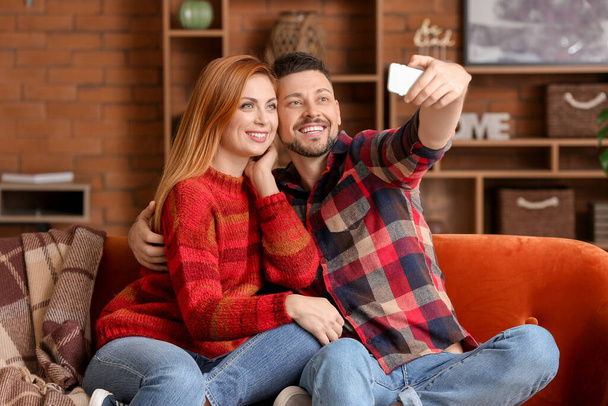 Happy couple taking selfie at home - Photo, Image